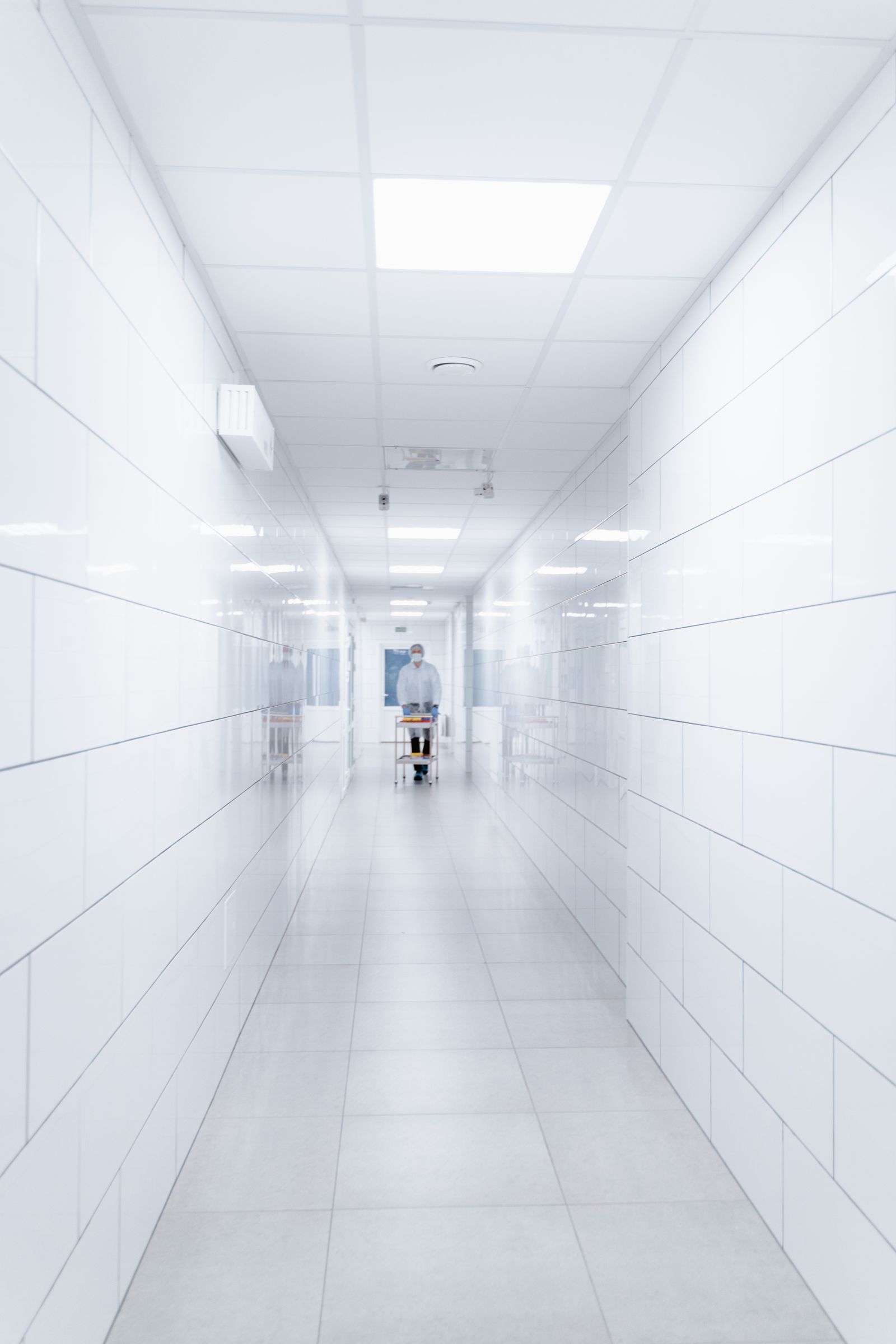 Clinician walking through a hospital corridor