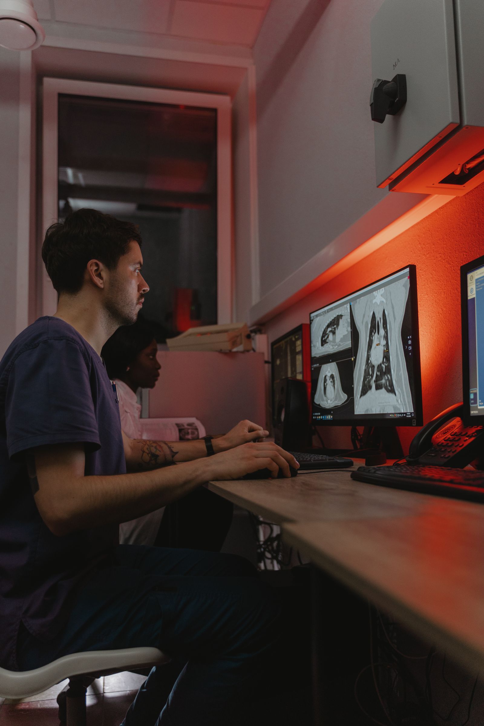 Clinicians reviewing diagnostic images on a workstation